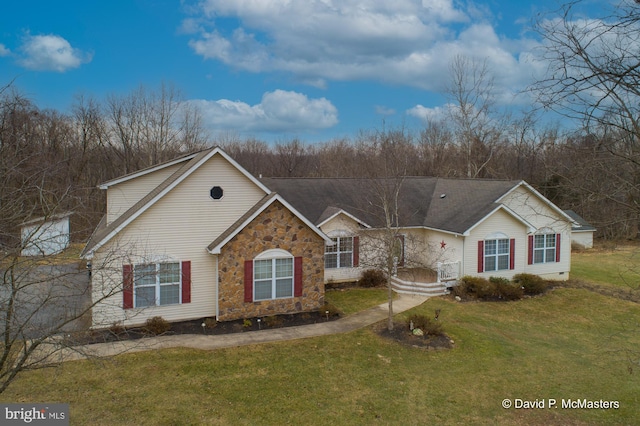 view of front of home with a front yard, stone siding, and crawl space