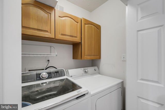 laundry room with cabinet space and independent washer and dryer