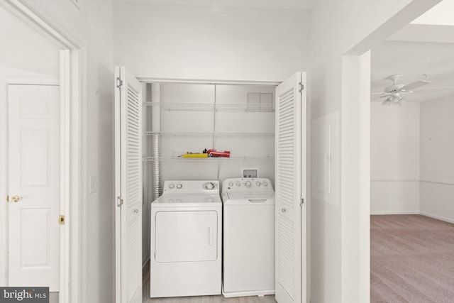 laundry room with separate washer and dryer, light carpet, and ceiling fan