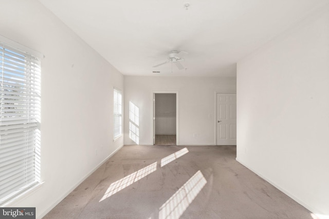 carpeted empty room featuring ceiling fan