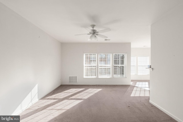 carpeted empty room featuring ceiling fan