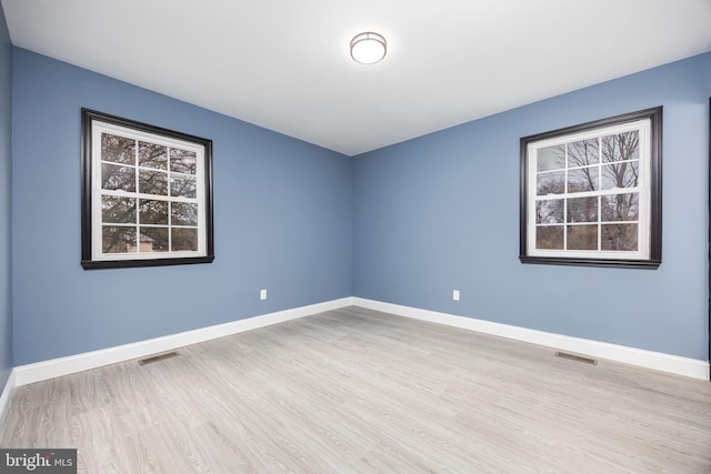 unfurnished room featuring light hardwood / wood-style flooring