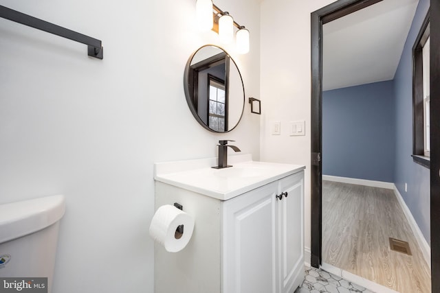 bathroom with vanity and toilet