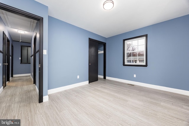 unfurnished room with light wood-type flooring