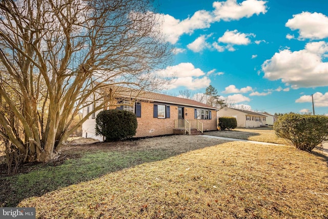 ranch-style house with a front lawn