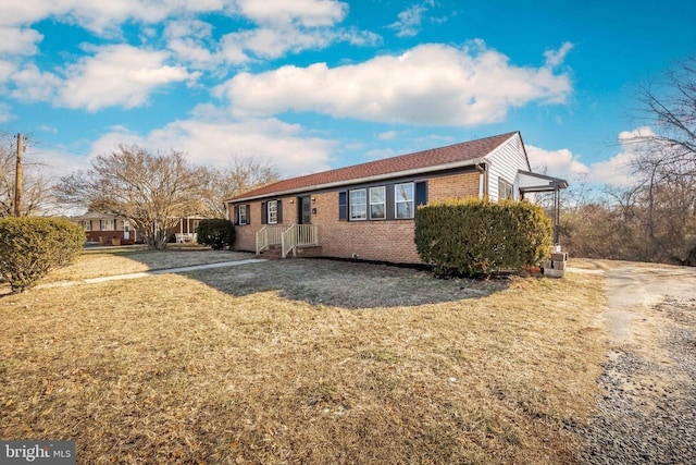 view of side of home with a yard