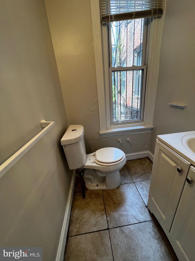 bathroom featuring tile patterned flooring, vanity, and toilet