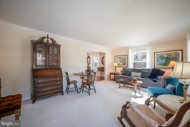 living room featuring ornamental molding and light carpet