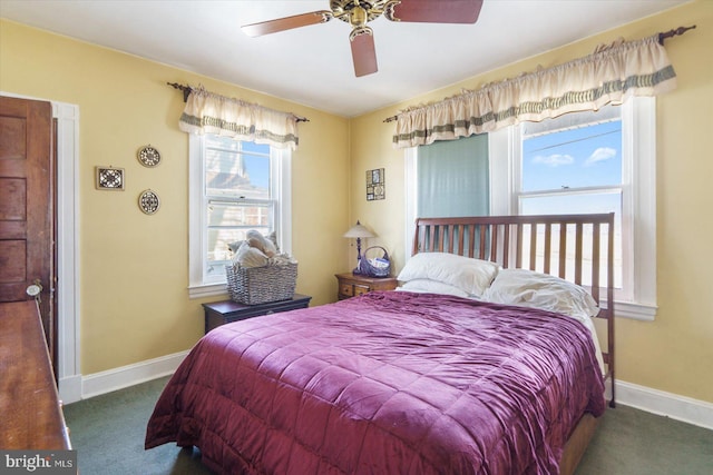 bedroom with ceiling fan and dark colored carpet