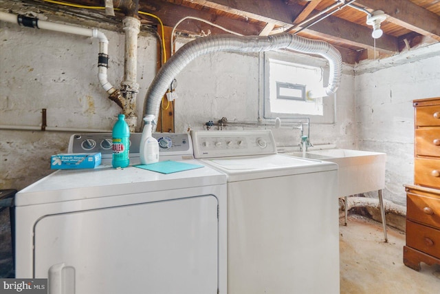 laundry room featuring washing machine and dryer and sink