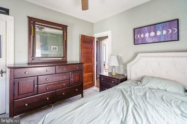 bedroom with ceiling fan and light carpet