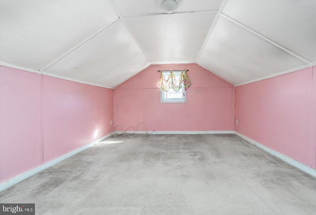 additional living space with vaulted ceiling and light colored carpet