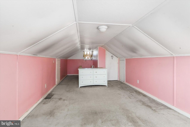 additional living space with vaulted ceiling and light carpet