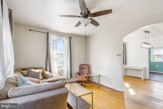 living room featuring ceiling fan and light wood-type flooring