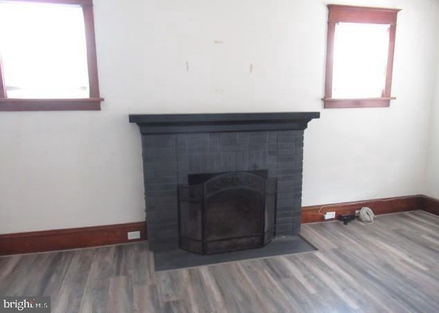 room details with a brick fireplace and hardwood / wood-style floors