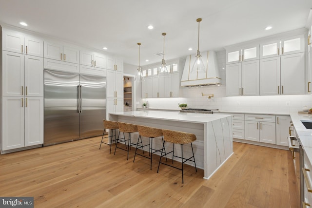 6919 Berkeley St, Falls Church, VA 22043 - kitchen with stainless steel built in refrigerator, custom exhaust hood, light wood-type flooring, white cabinets, and recessed lighting