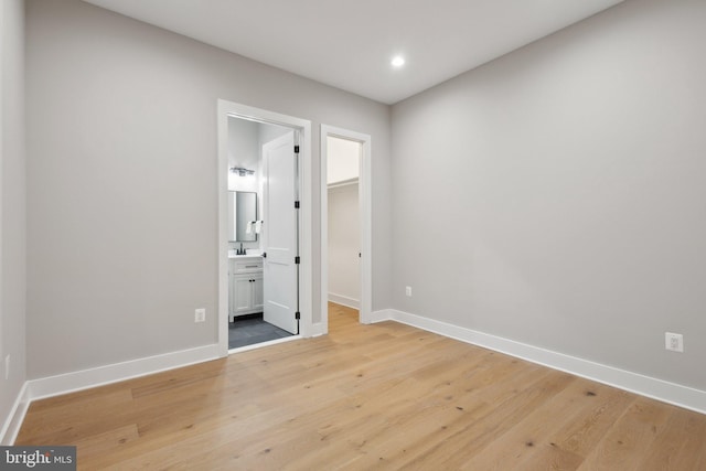 6919 Berkeley St, Falls Church, VA 22043 - unfurnished bedroom with light wood finished floors, baseboards, a walk in closet, recessed lighting, and connected bathroom