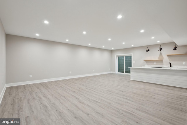 6919 Berkeley St, Falls Church, VA 22043 - unfurnished living room featuring recessed lighting, light wood-style flooring, baseboards, and a sink