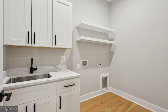 6919 Berkeley St, Falls Church, VA 22043 - laundry room featuring hookup for an electric dryer, washer hookup, baseboards, light wood finished floors, and cabinet space
