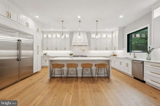 6919 Berkeley St, Falls Church, VA 22043 - kitchen featuring appliances with stainless steel finishes, custom exhaust hood, a sink, a kitchen bar, and decorative backsplash
