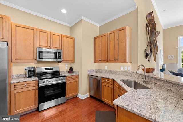 kitchen featuring sink, crown molding, stainless steel appliances, dark hardwood / wood-style floors, and light stone counters