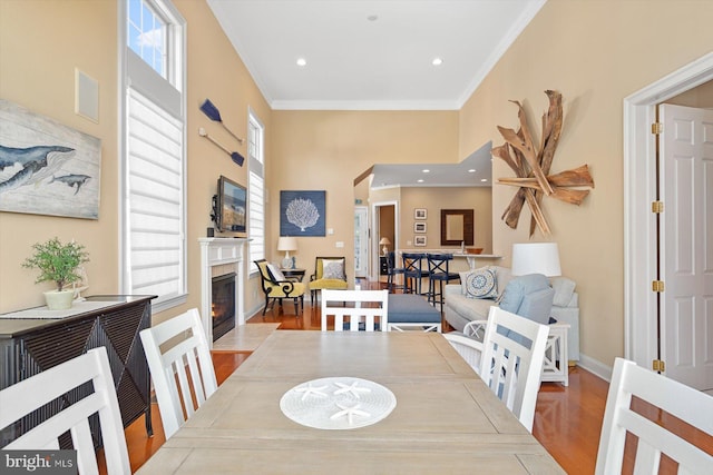 dining room featuring ornamental molding, light hardwood / wood-style floors, and a healthy amount of sunlight