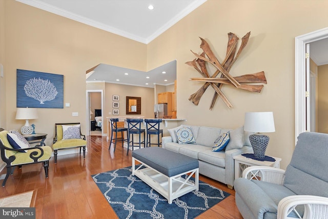 living room with hardwood / wood-style floors and ornamental molding