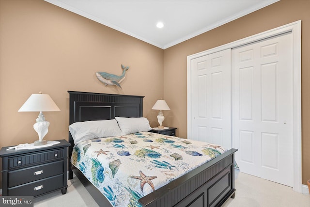 carpeted bedroom featuring crown molding and a closet