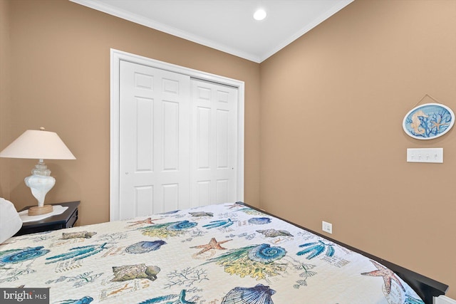 bedroom with crown molding and a closet