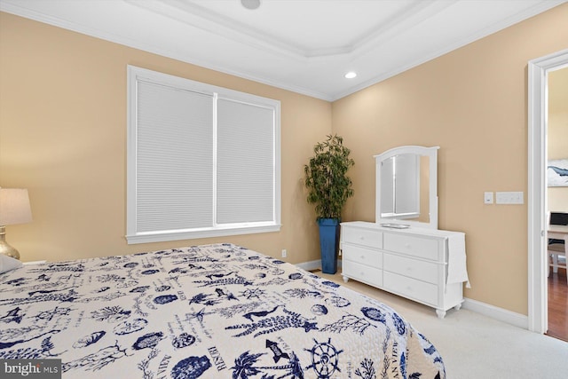 bedroom featuring a raised ceiling, crown molding, and light carpet