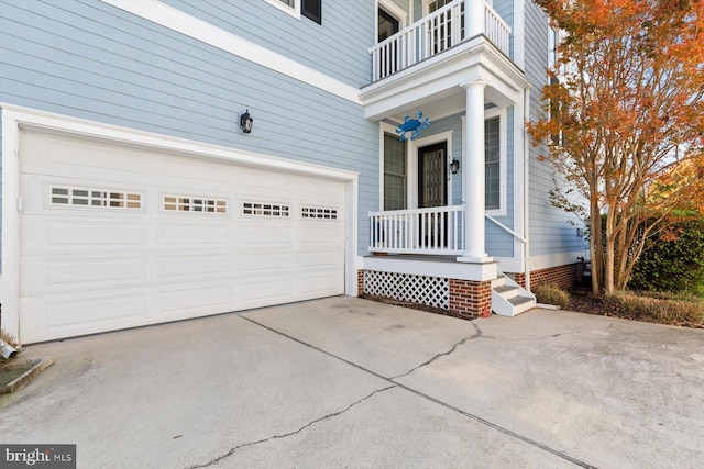 doorway to property featuring a balcony and a garage