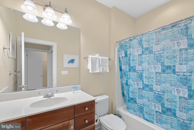 full bathroom with vanity, shower / bath combo, and toilet