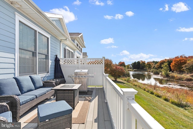 deck with a water view, a grill, and an outdoor hangout area