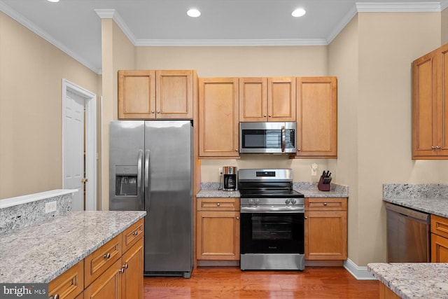 kitchen with light stone countertops, crown molding, appliances with stainless steel finishes, and light hardwood / wood-style floors