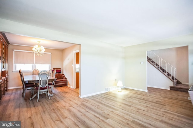 dining room featuring an inviting chandelier and light wood-type flooring