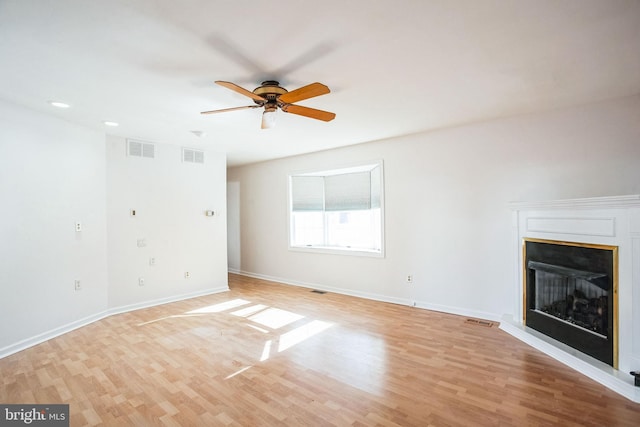 unfurnished living room with light hardwood / wood-style flooring and ceiling fan