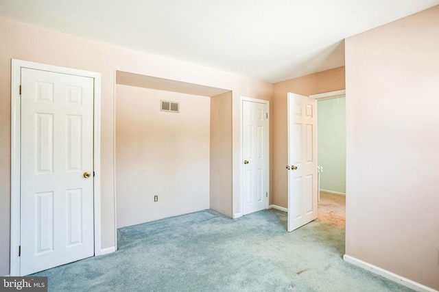 unfurnished bedroom with light carpet