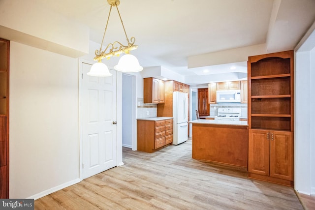 kitchen with light hardwood / wood-style flooring, kitchen peninsula, pendant lighting, white appliances, and backsplash