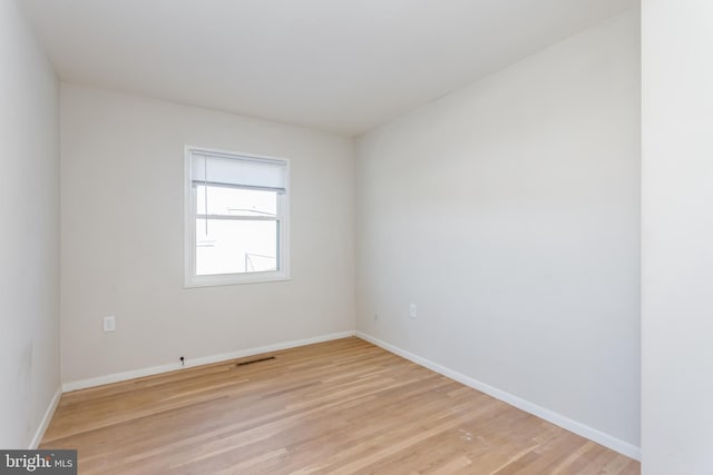 empty room with light hardwood / wood-style flooring