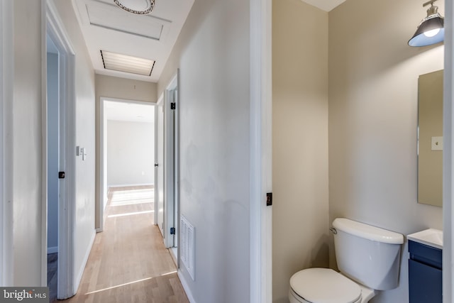 bathroom featuring vanity, hardwood / wood-style floors, and toilet