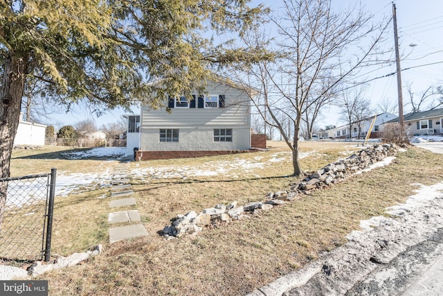 view of side of home with a yard