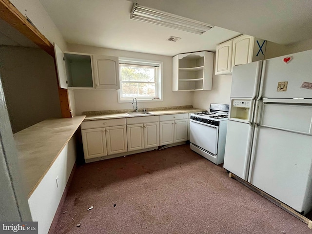 kitchen with sink, white cabinets, and white appliances