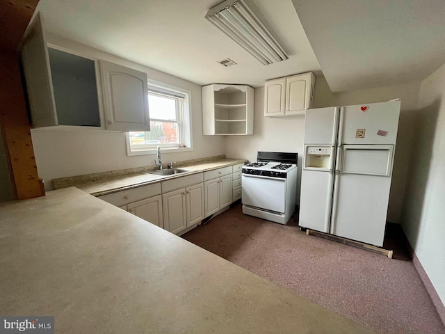 kitchen featuring white cabinetry, white appliances, sink, and dark colored carpet