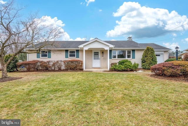 ranch-style home with a garage and a front yard