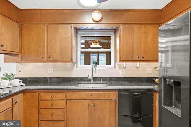 kitchen featuring stainless steel refrigerator with ice dispenser, dishwasher, sink, and dark stone countertops