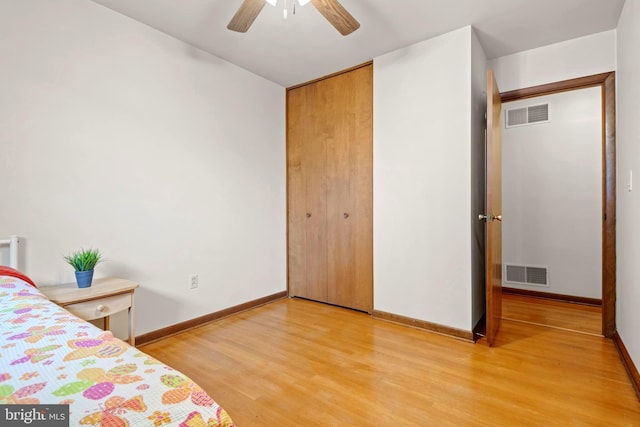 unfurnished bedroom with hardwood / wood-style flooring, a closet, and ceiling fan