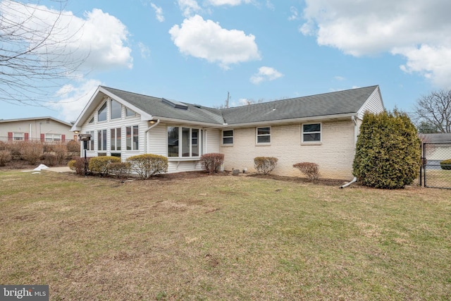 rear view of property with a yard