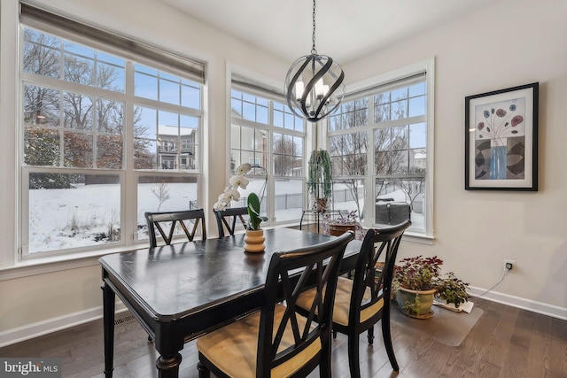 dining area featuring dark hardwood / wood-style flooring and a chandelier