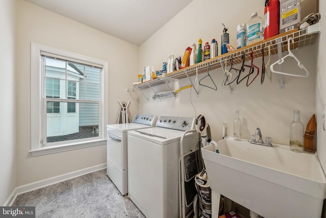 laundry area with washing machine and dryer and sink