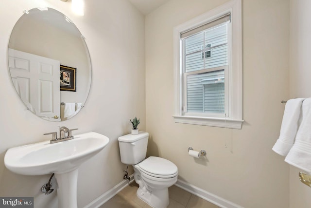 bathroom with tile patterned floors and toilet